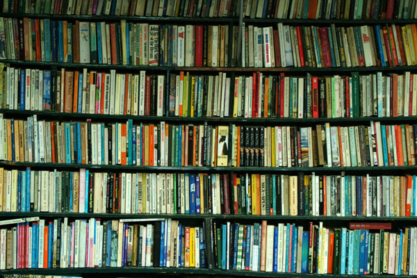 Crowded shelves of books in a bookstore. 